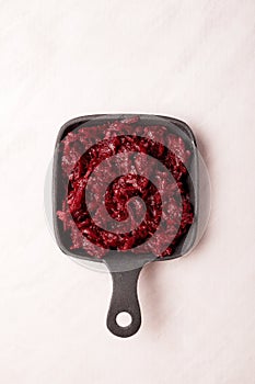 Fried beetroot with tomato and basil in frying pan. Close-up, place for text. Healthy ingredient for vegetarian salad or borscht