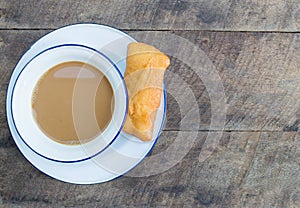 Fried bread and coffee in a white cup and country style