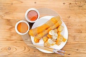 Fried bread stick or You Tiao served with Chinese tea. photo