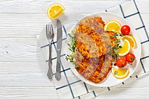 fried breaded chicken breast cutlets on plate