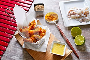 Fried breaded squid and curry sauce and lime