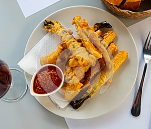 Fried calcots in tempura with romesco sauce