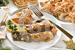 Fried carp fillets with sauerkraut and puff pastry pies with mushrooms for Christmas Eve supper