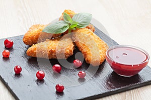 Fried cheese sticks served with cranberries, sauce on black stone