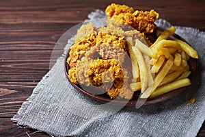 Fried Chicken breast on an old rustic wooden background