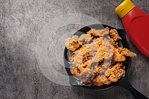 Fried chicken, crispy, in a black pan