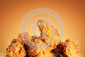 Fried chicken or crispy kentucky on brown background. Delicious hot meal with fast food photo