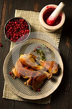 Fried chicken with delicious juicy lingonberry sauce on a plate, top view