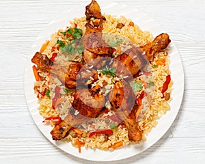 fried chicken drumsticks over rice pilaf, top view