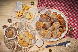 Fried chicken egg tart and french fries in wooden plate on wooden background, Deep fry Chicken and nuggets on wooden table.