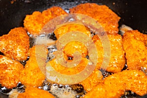 Fried chicken fillet, breaded in a pan