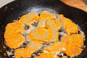 Fried chicken fillet, breaded in a pan