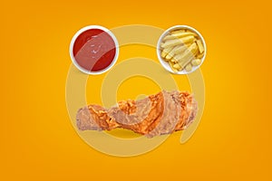 Fried Chicken with french fries isolated on orange colored background.