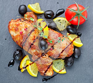 Fried chicken. Fried chicken legs with lemon and olives