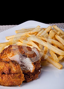 Fried Chicken and fried potato in plate and black background