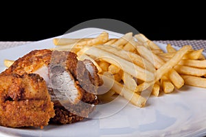 Fried Chicken and fried potato in plate and black background