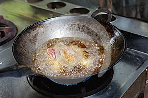 Fried chicken in hot oil and boiling in pan