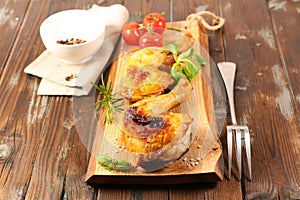 Fried chicken leg on wooden board