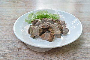 Fried chicken liver and gizzard with pepper couple garlic on plate