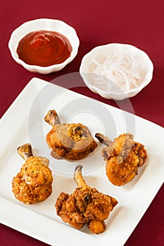 Fried chicken lollipops with ketchup