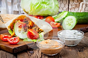 Fried chicken meat with vegetables in pita bread