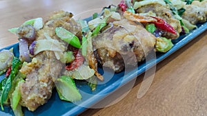 Fried chicken with salted egg in blue ceramic plate