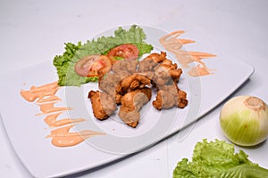 fried chicken with sauce and vegetables