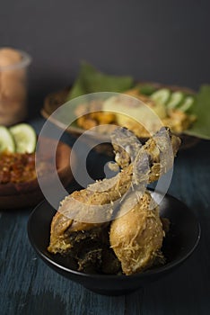 Fried chicken with serundeng fried coconut in dark mood theme