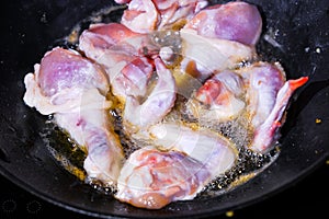 Fried chicken slices in a frying pan