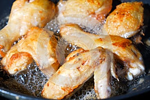 Fried chicken slices in a frying pan