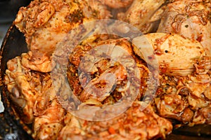 Fried chicken with spices in a pan