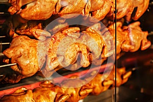 Fried chicken on a spit in an electric grill oven