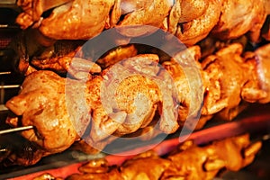 Fried chicken on a spit in an electric grill oven