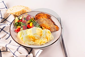 Fried chicken steak or schnitzel with mashed potatoes and vegetables salad in plate