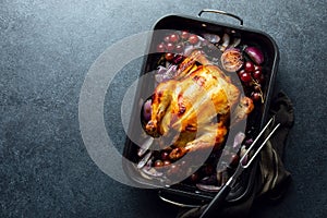 Fried chicken or turkey in a dark baking tray, top-down view