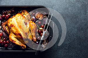 Fried chicken or turkey in a dark baking tray, top-down view