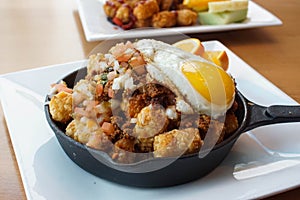 Fried chicken and waffles with eggs benedict on top