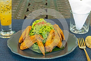 Fried chicken wing and vegetable on dish