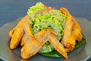Fried chicken wing and vegetable on dish