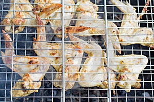 Fried chicken wings on barbecue grill. Fast food product