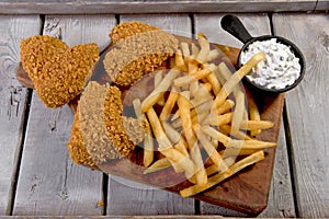 Fried chicken wings breaded crispy with sauce and french fries