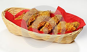 Fried Chicken wings, close-up, on red napkins, in a basket