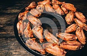 Fried chicken wings on a grill