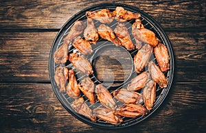 Fried chicken wings on a grill