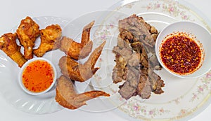Fried chicken wings and legs with grilled pork and Thai spicy sauce