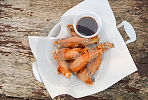 fried chicken wings with sauce thai food on wooden table food background