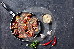 Fried chicken wings in teriyaki sauce, flatlay