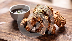 Fried chicken wings on wooden butcher board