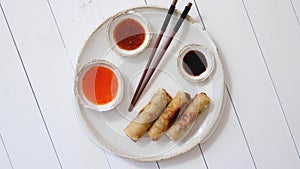 Fried Chinese Thai or Vietnamese traditional spring rolls or nems served on ceramic plate