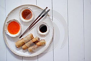 Fried Chinese Thai or Vietnamese traditional spring rolls or nems served on ceramic plate
